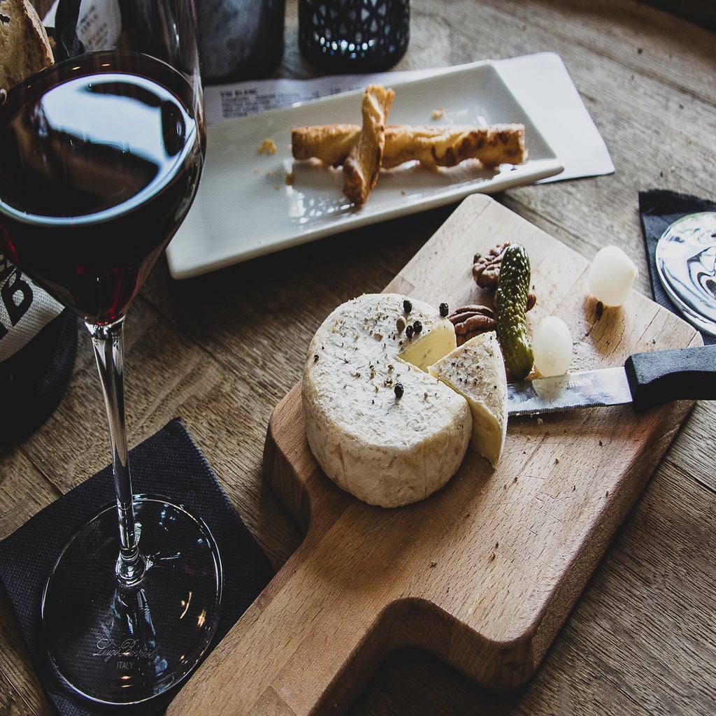 martini glass near a board with cheese