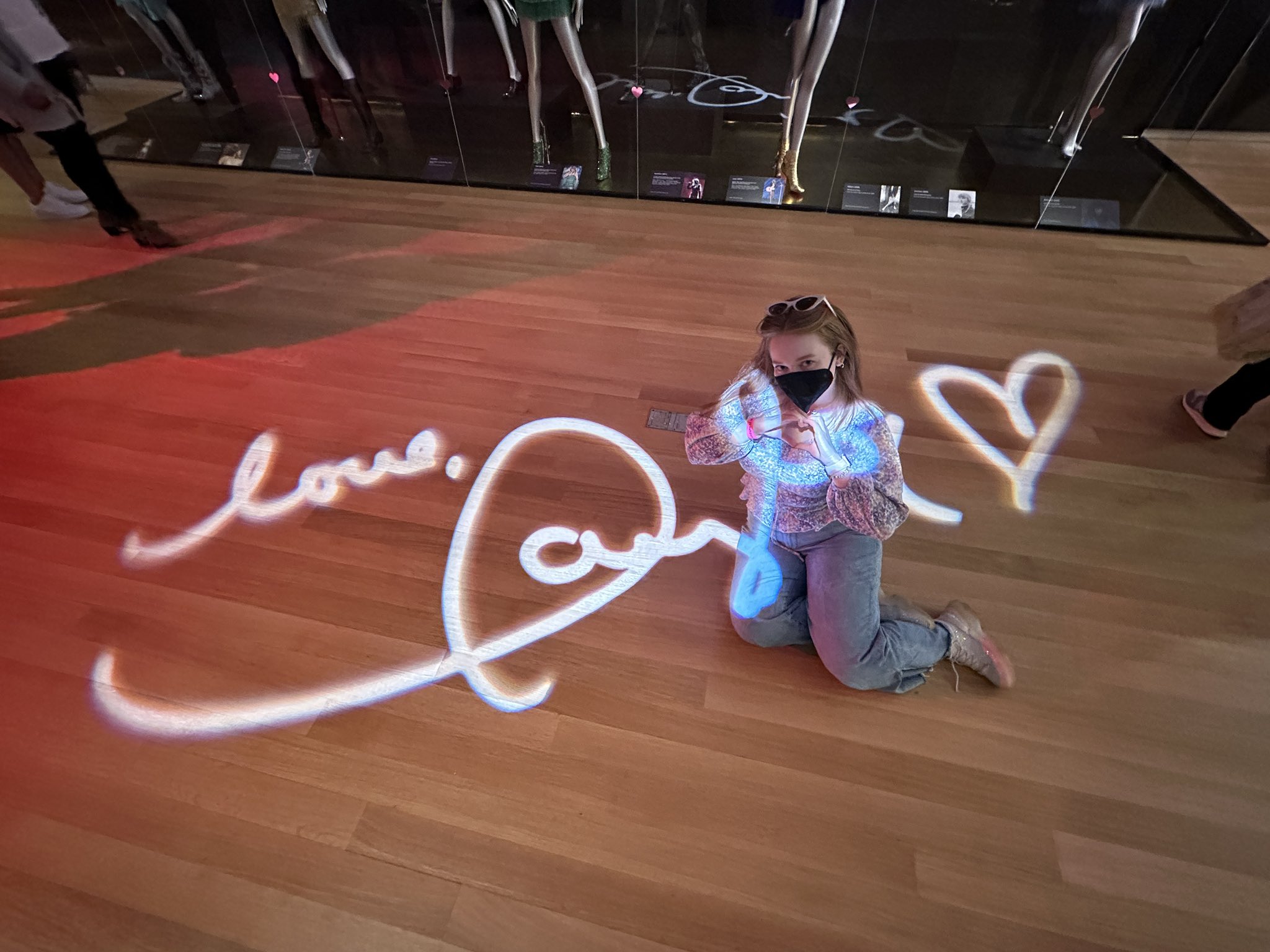 Allie sitting on the floor with Love, Taylor projection