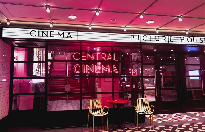 Outside a cinema with pink lighting