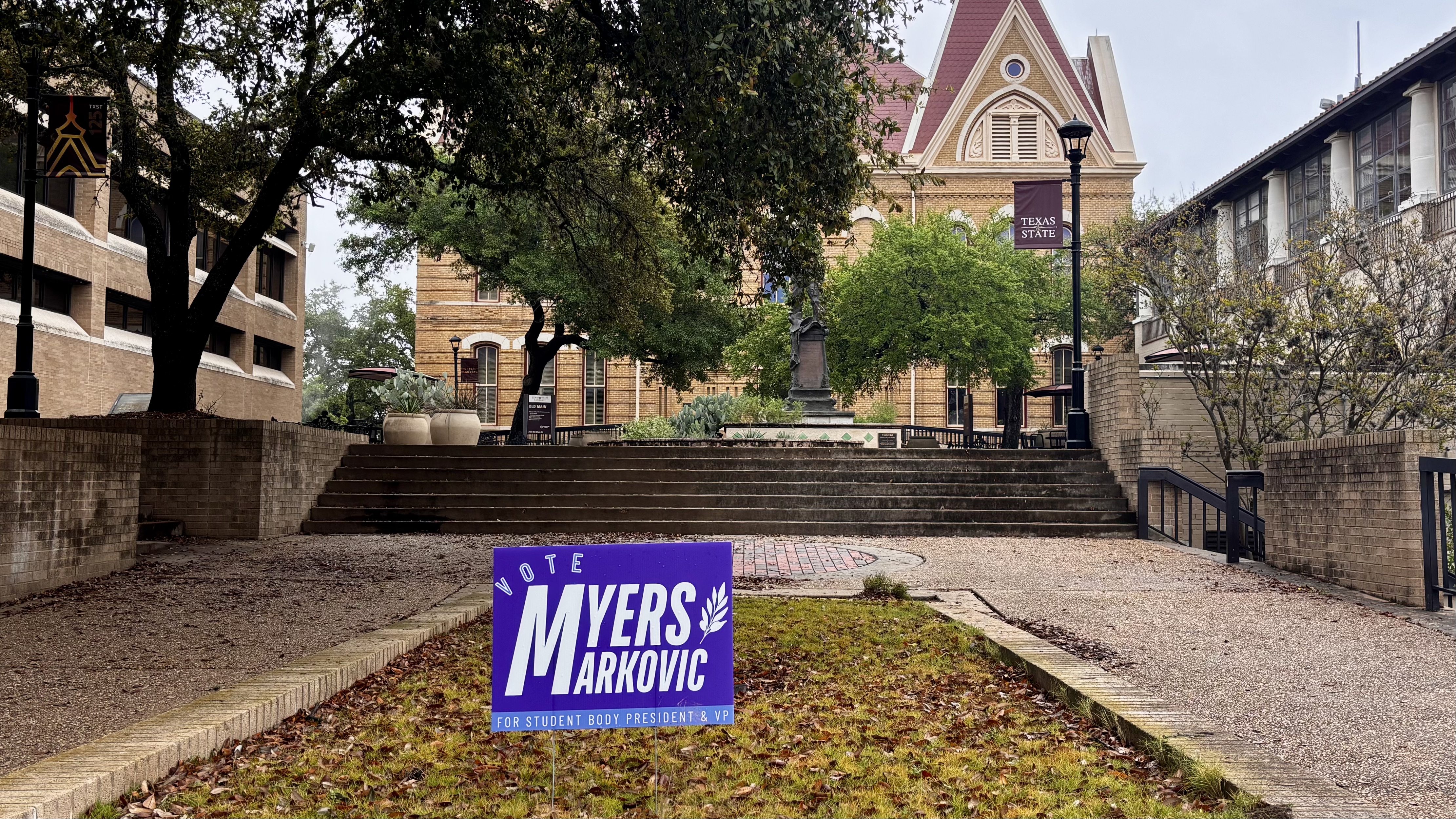 Picture of TXST\'s Old Main with Myers campaign poster.