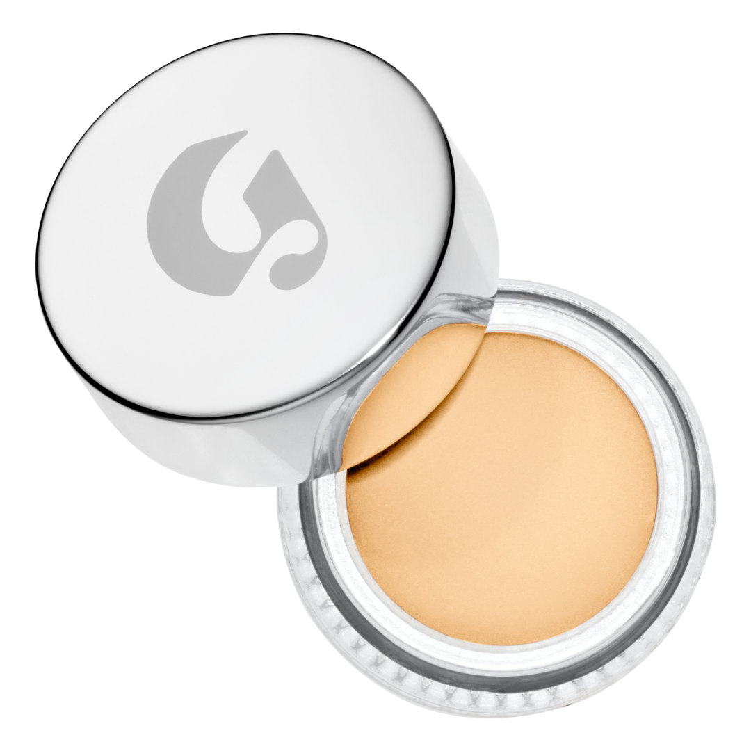 light-toned cream concealer in a silver jar