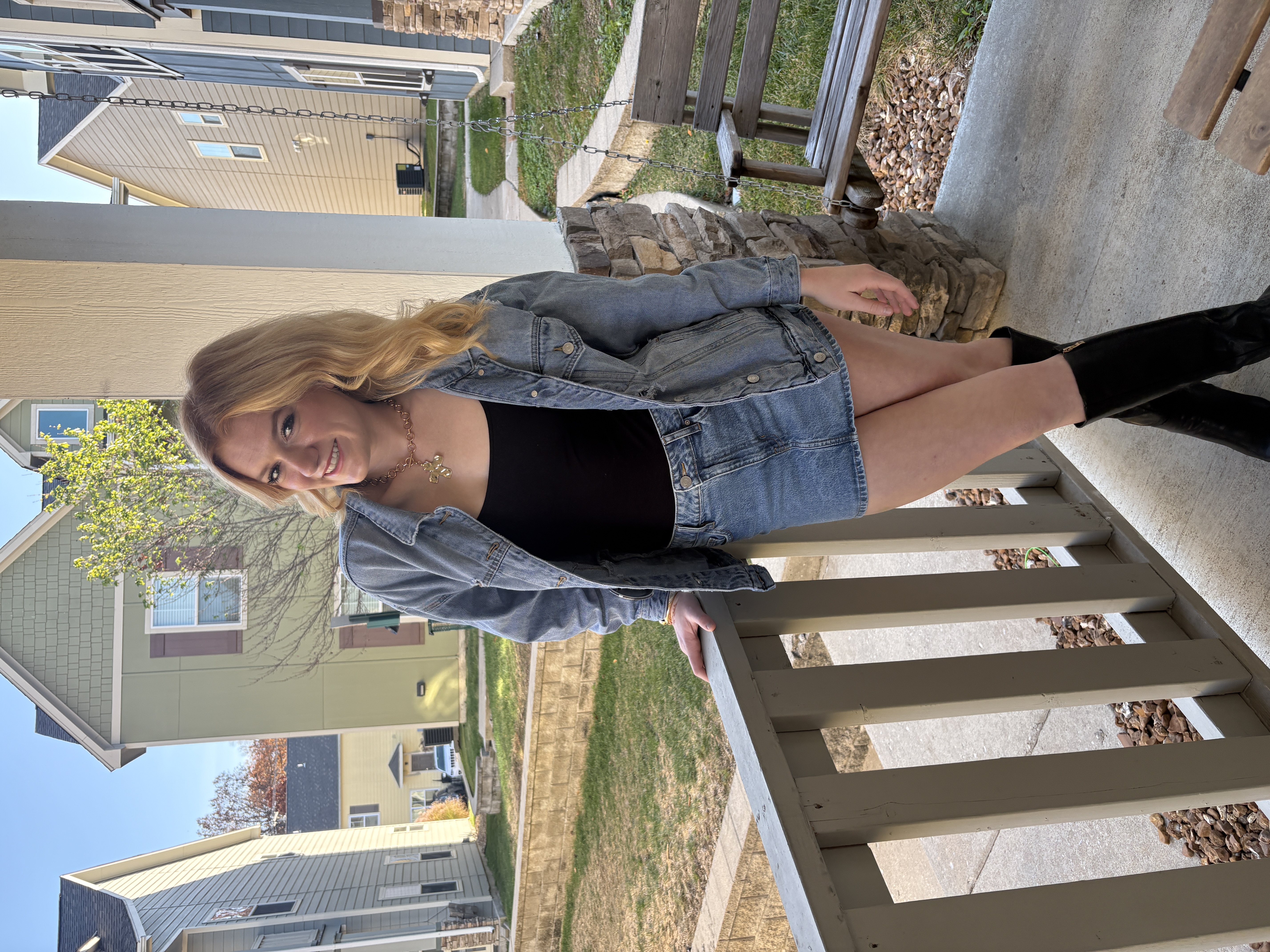 A girl on a porch before a game -- highlighting the Black Boots