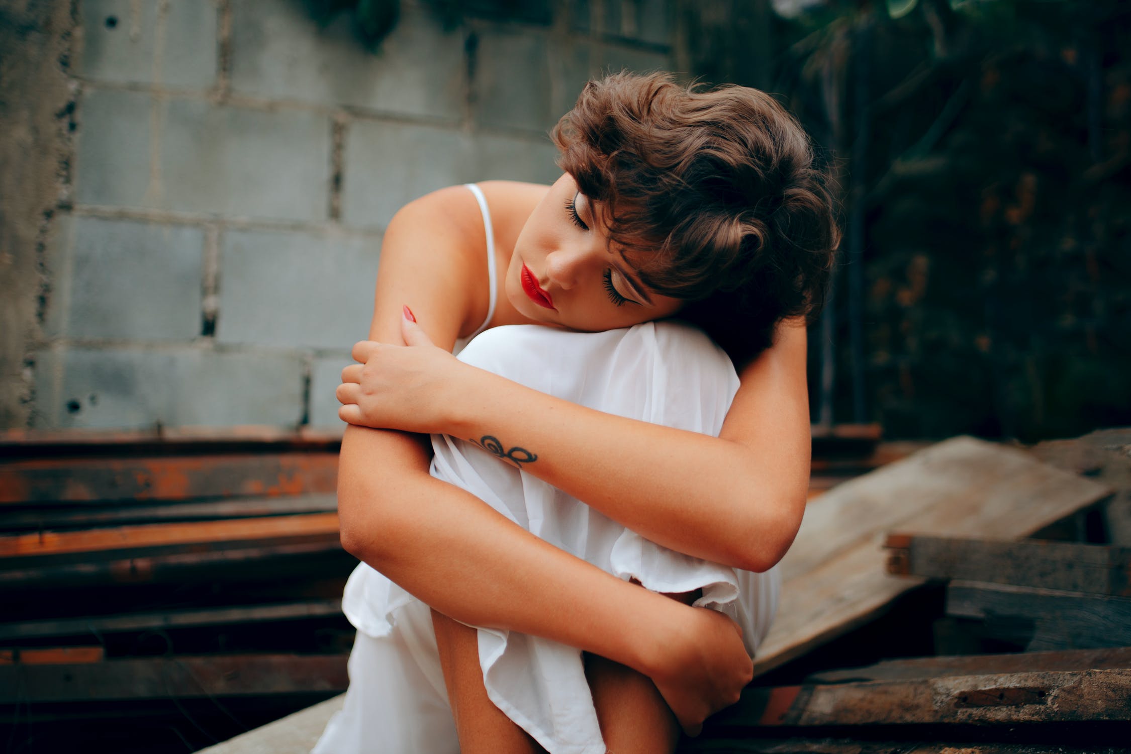 women squatting near wall