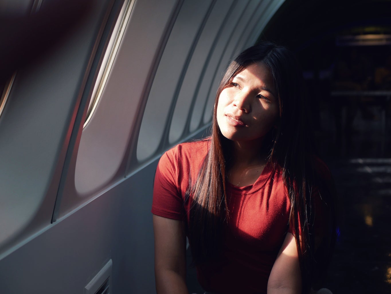 Woman on a plane looking out the window.
