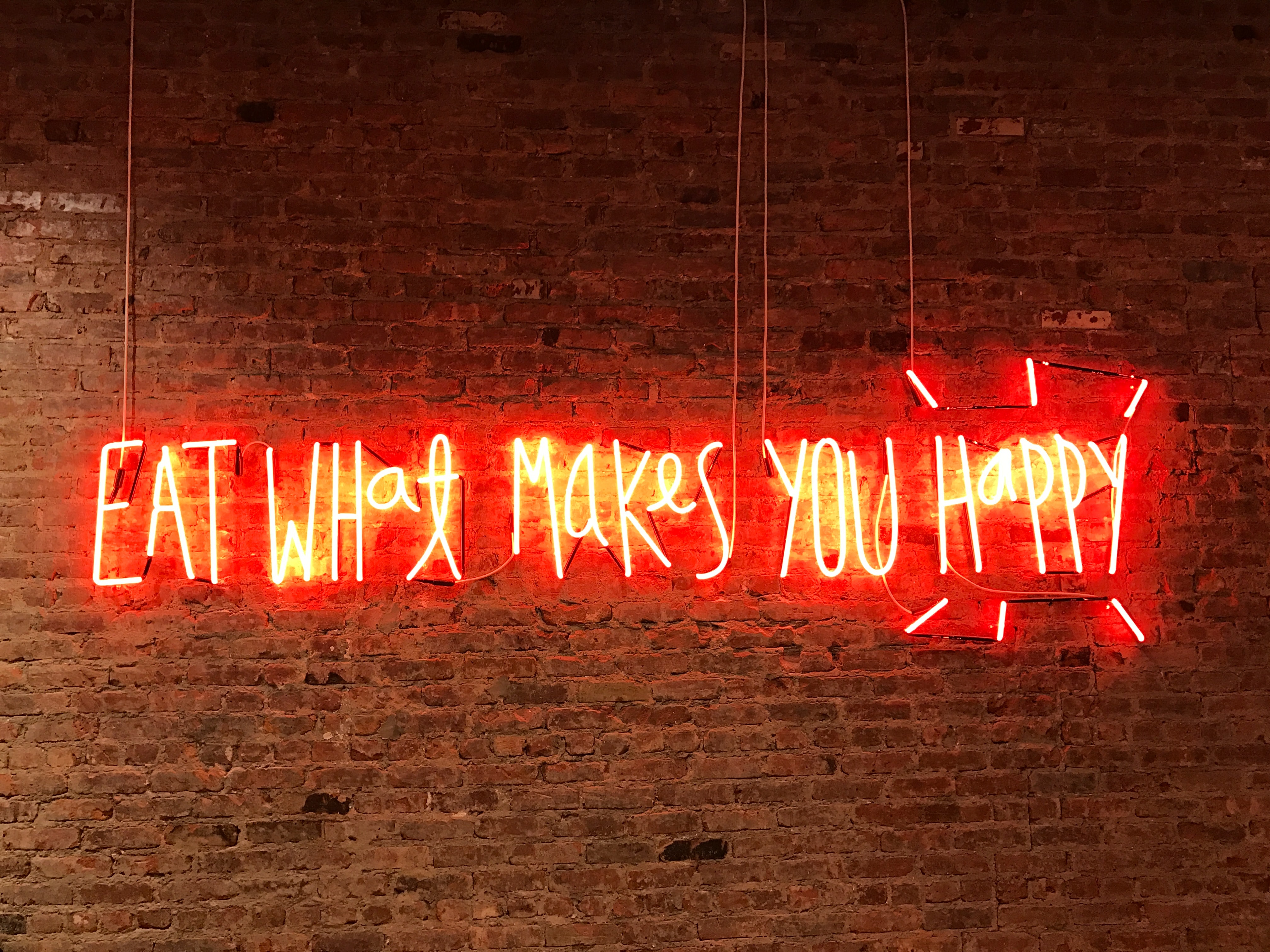 Eat what makes you happy neon sign by Jon Tyson