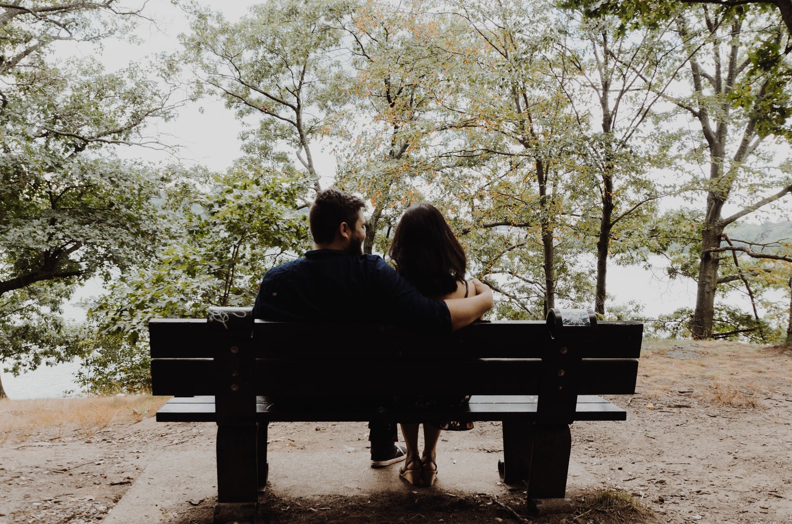 Couple talking on park bench
