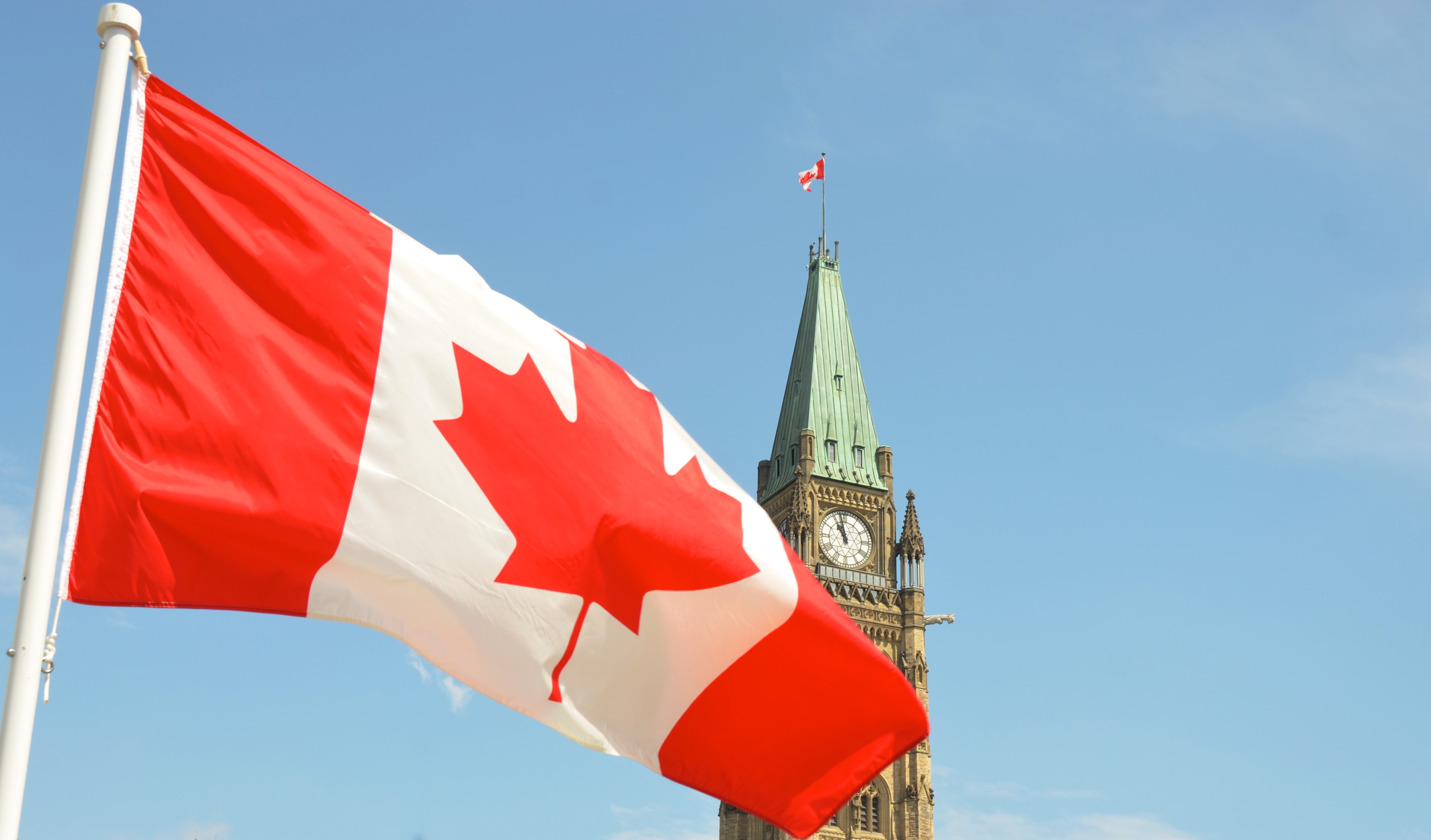 Canadian flag flying at parliament building in Ottawa ON Canada