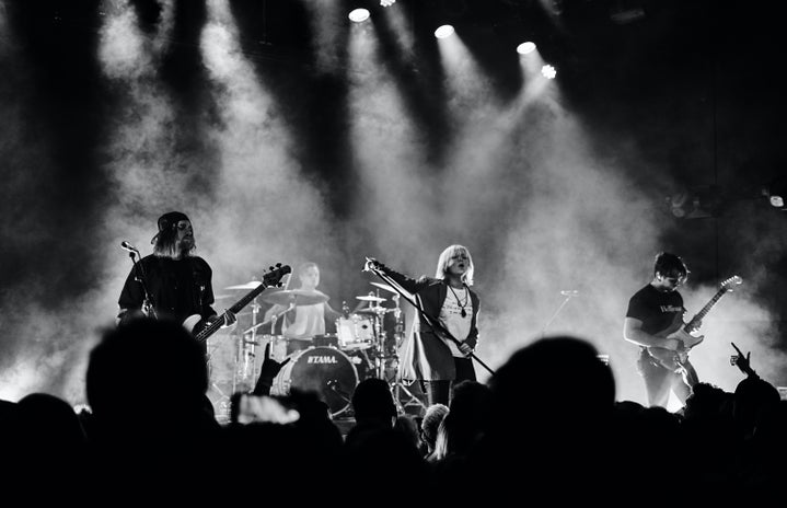 Black and white photo of a band playing in concert