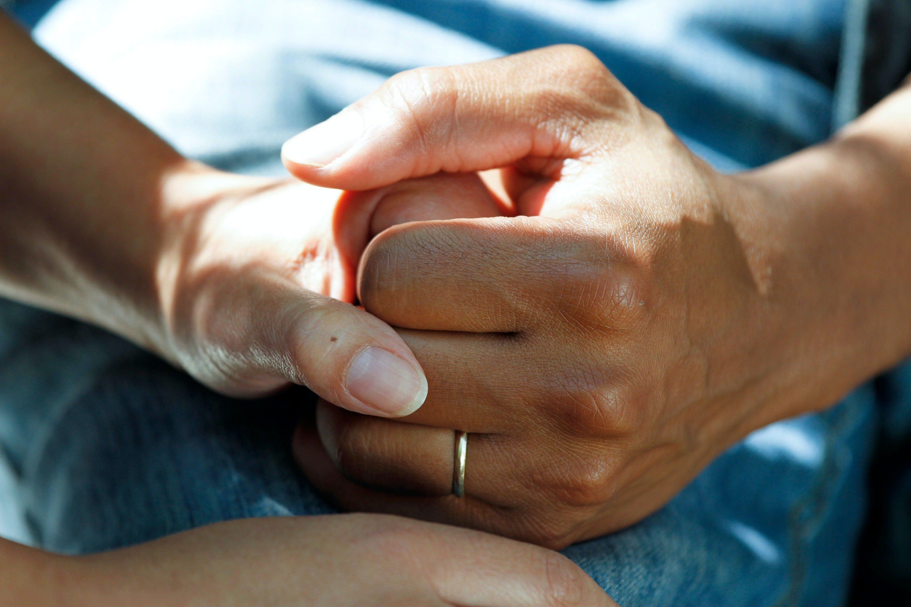 A patient holding hands with their doctor