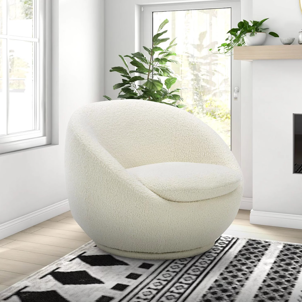 white plush chair on a black and white rug