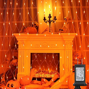 Orange lights in front of a white fireplace.