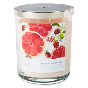 peach-colored candle with illustrations of grapefruit on the label