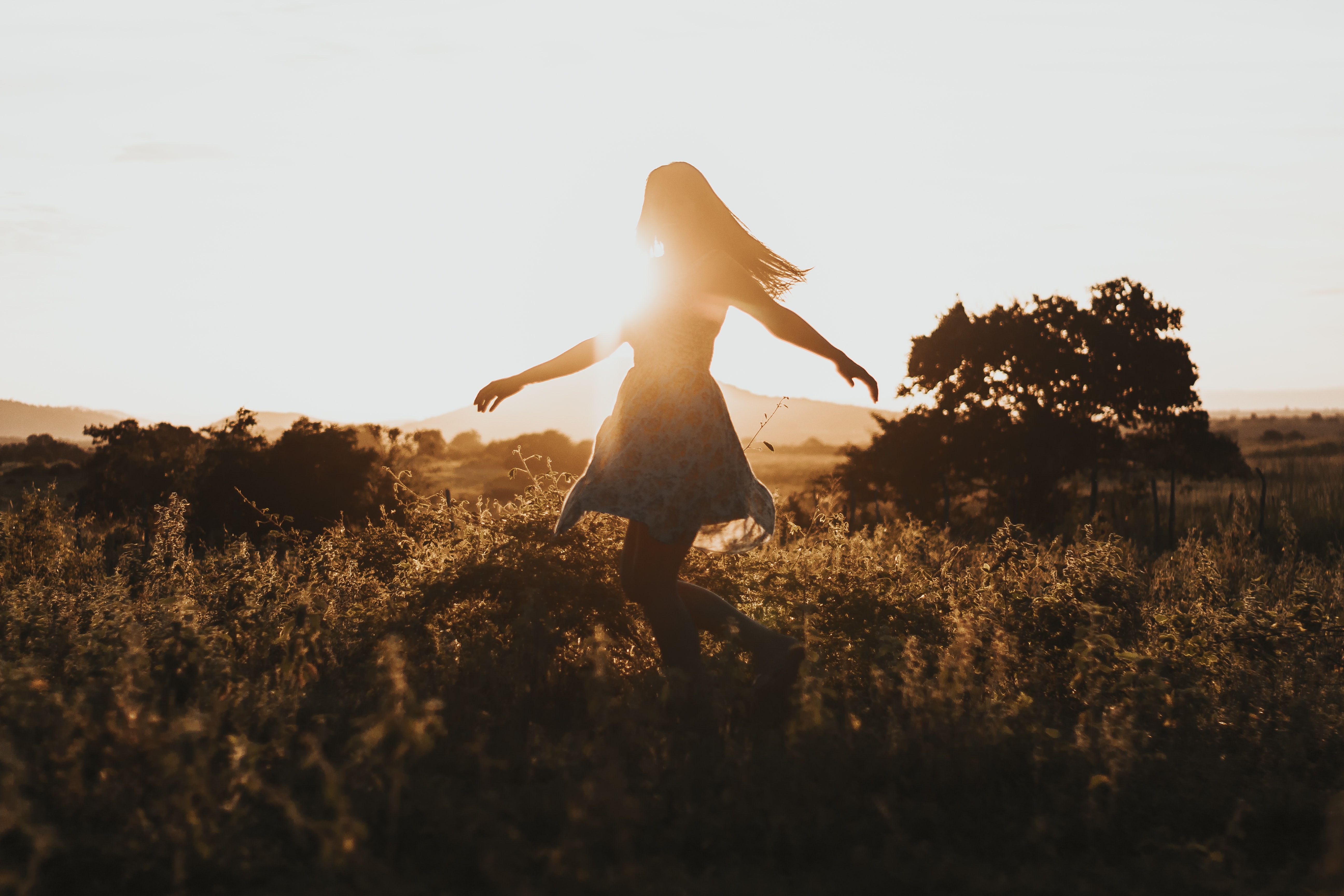 silhouette of woman dancing in field by Jackson David on Unsplash?width=698&height=466&fit=crop&auto=webp&dpr=4