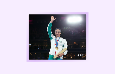 PARIS, FRANCE - AUGUST 09: Gold Medallist Imane Khelif of Team Algeria acknowledges the crowd from the podium during the Boxing Women\'s 66kg medal ceremony after the Boxing Women\'s 66kg Final match on day fourteen of the Olympic Games Paris 2024 at Roland Garros on August 09, 2024 in Paris, France.