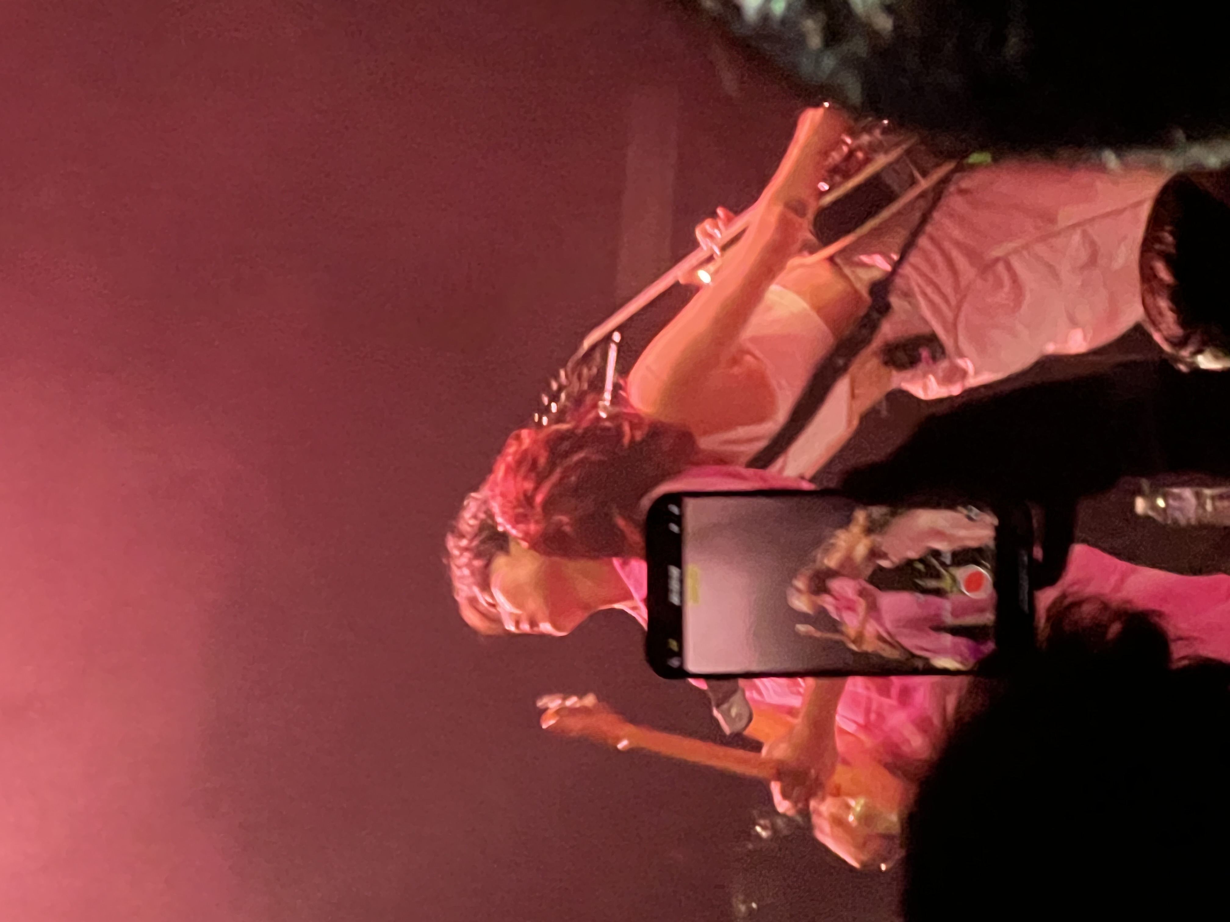 Singer and guitarist leaning against each other