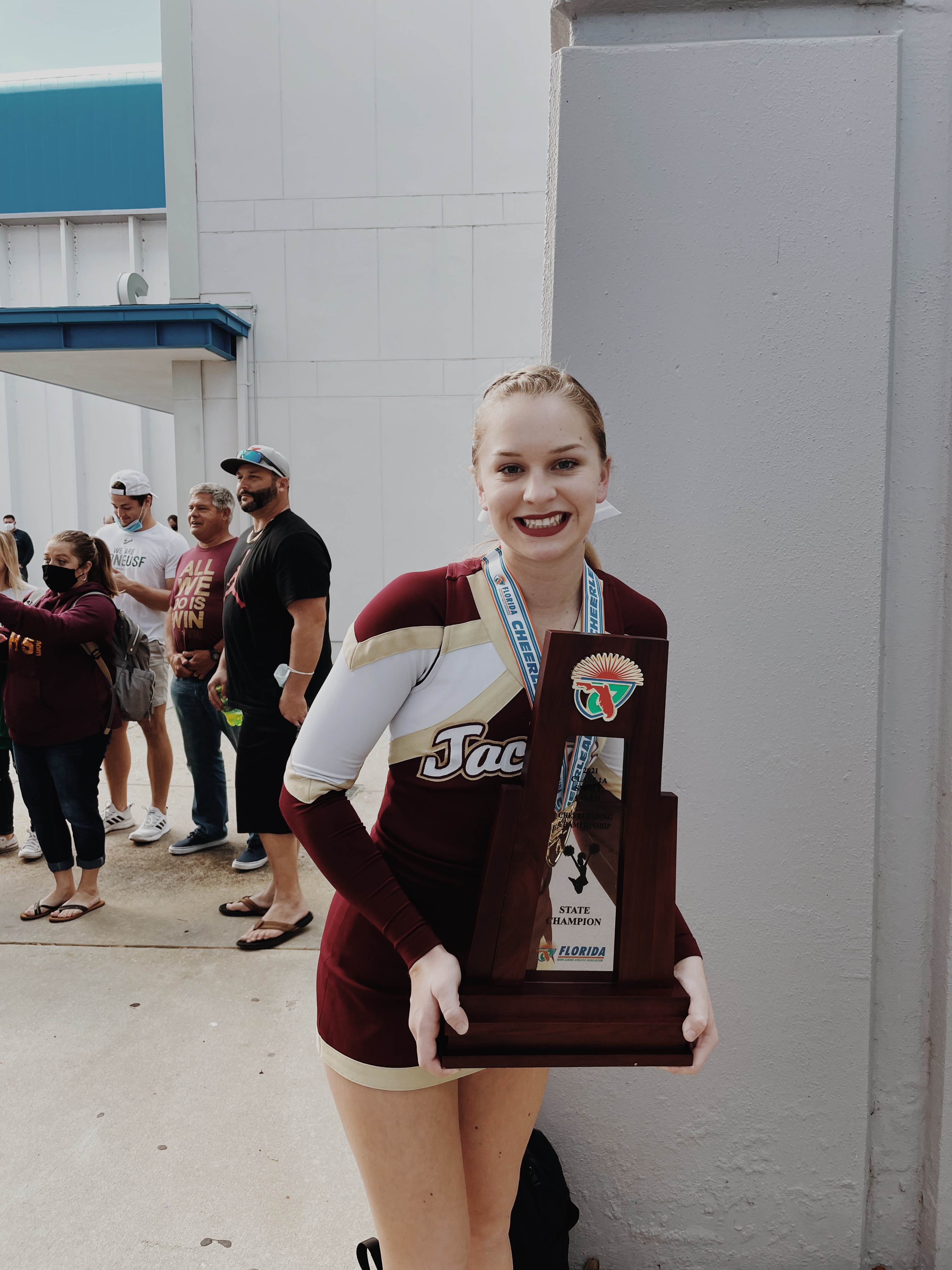 cheerleader holding trophy