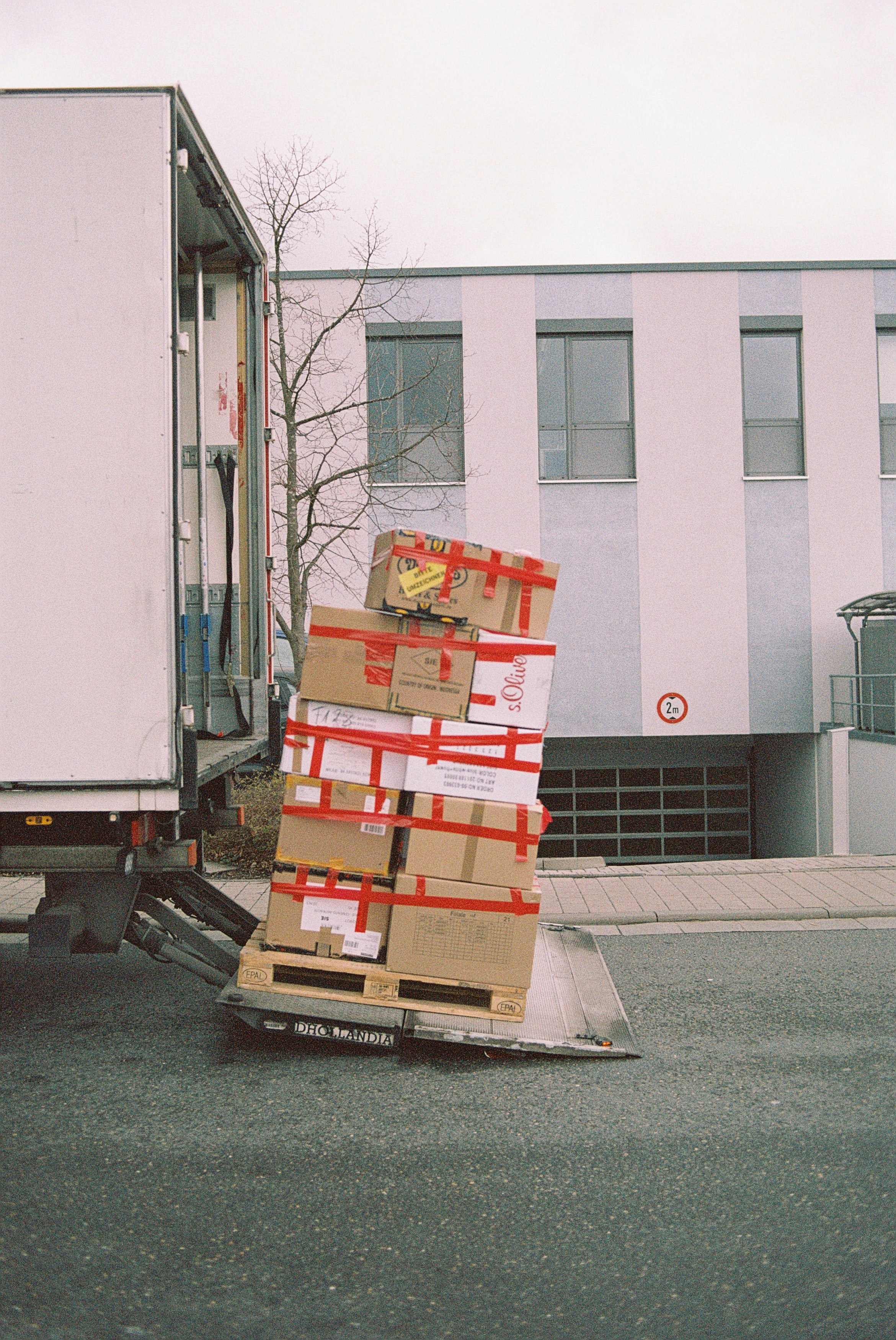 brown cardboard boxes on grey asphalt