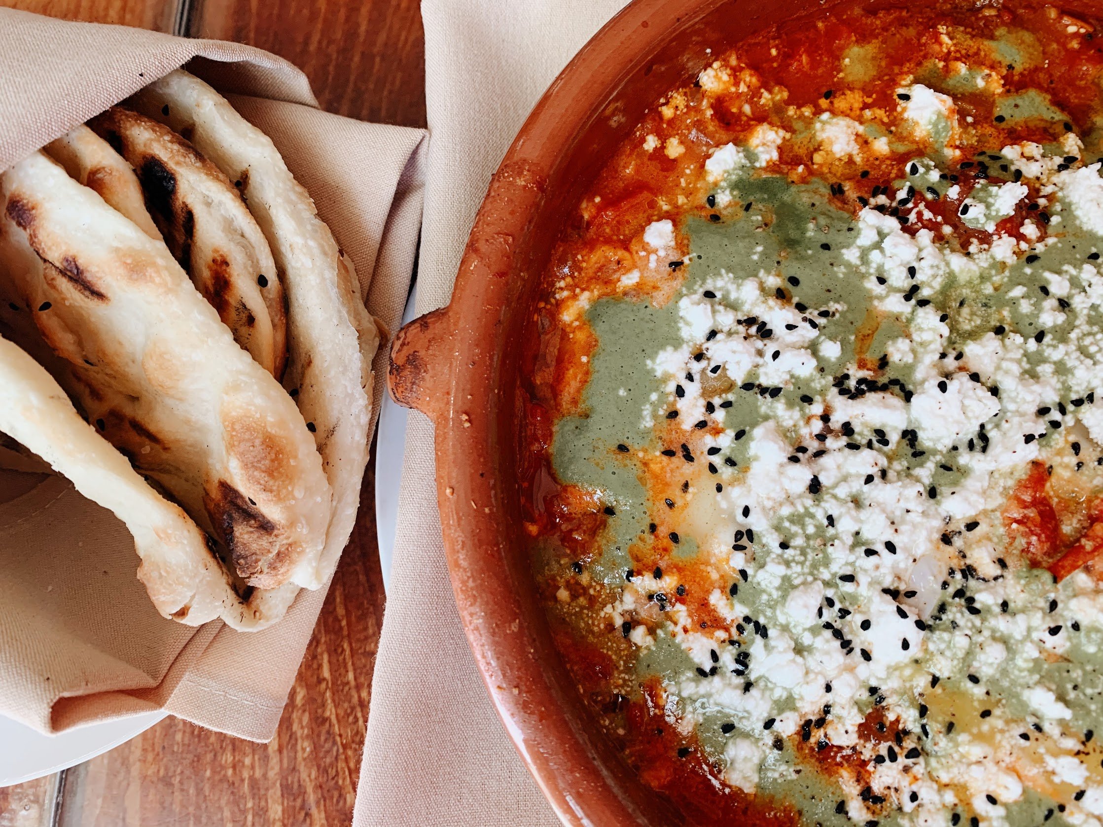 photo of shakshuka and pita bread