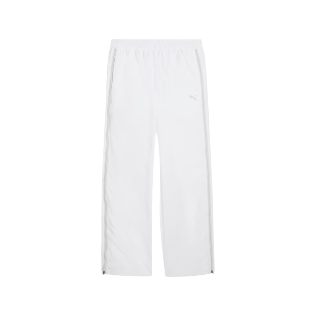 White track pants with an elastic waistband and subtle side stripes. The pants are designed for comfort and feature a minimalist, sporty style.