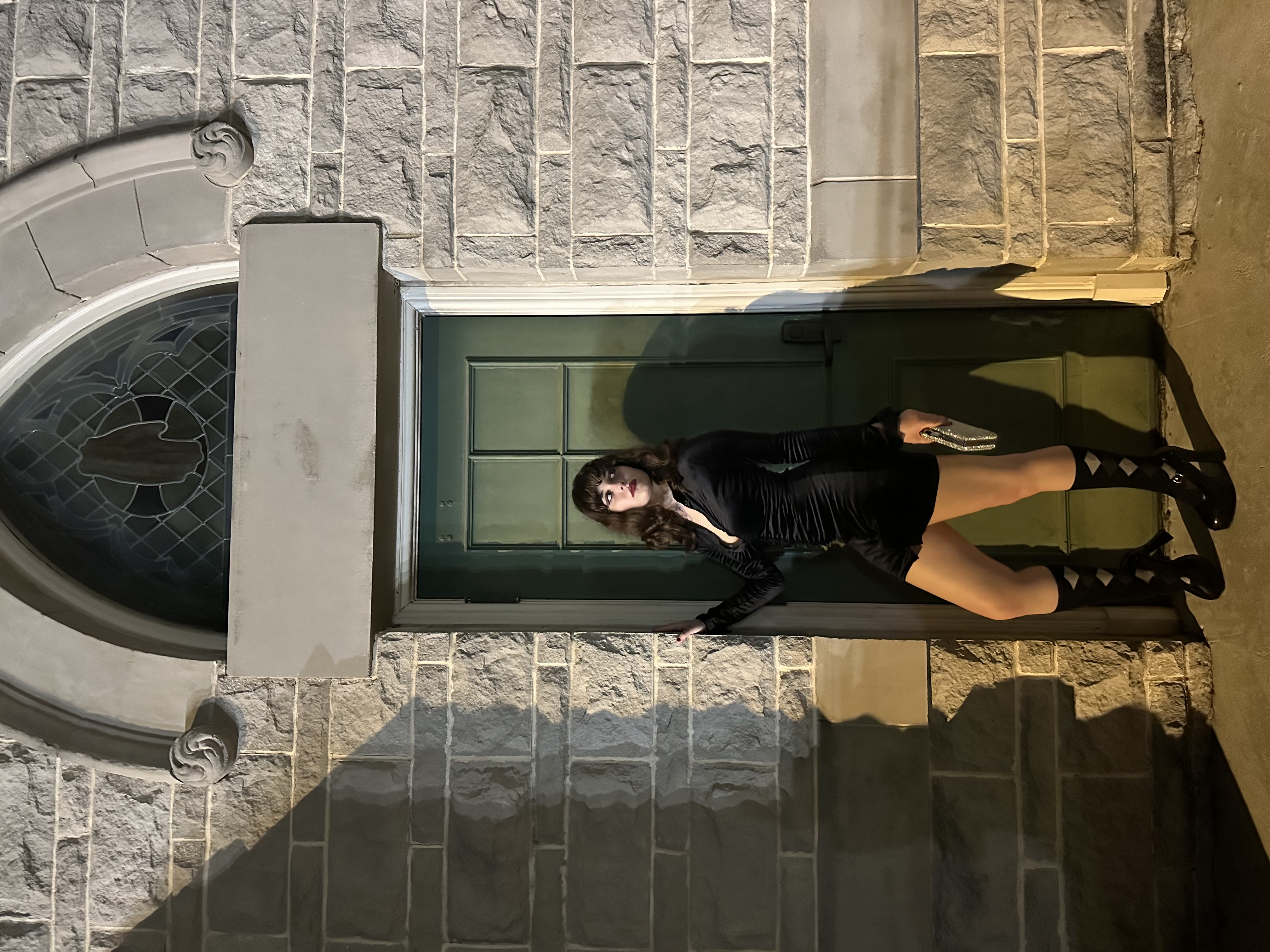 Girl in all black posing in doorway