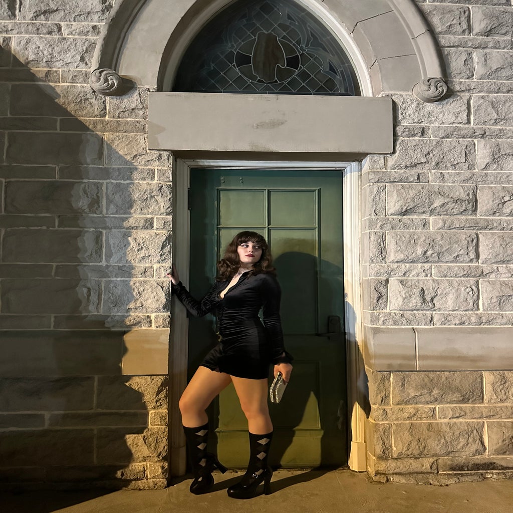 Girl in all black posing in doorway