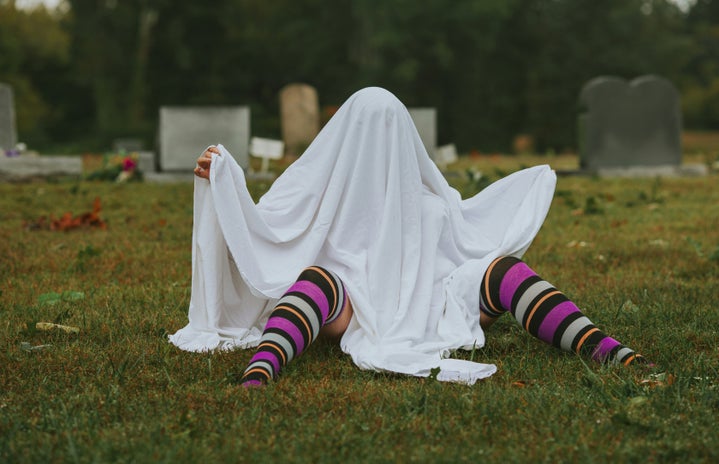 Ghost costume in graveyard