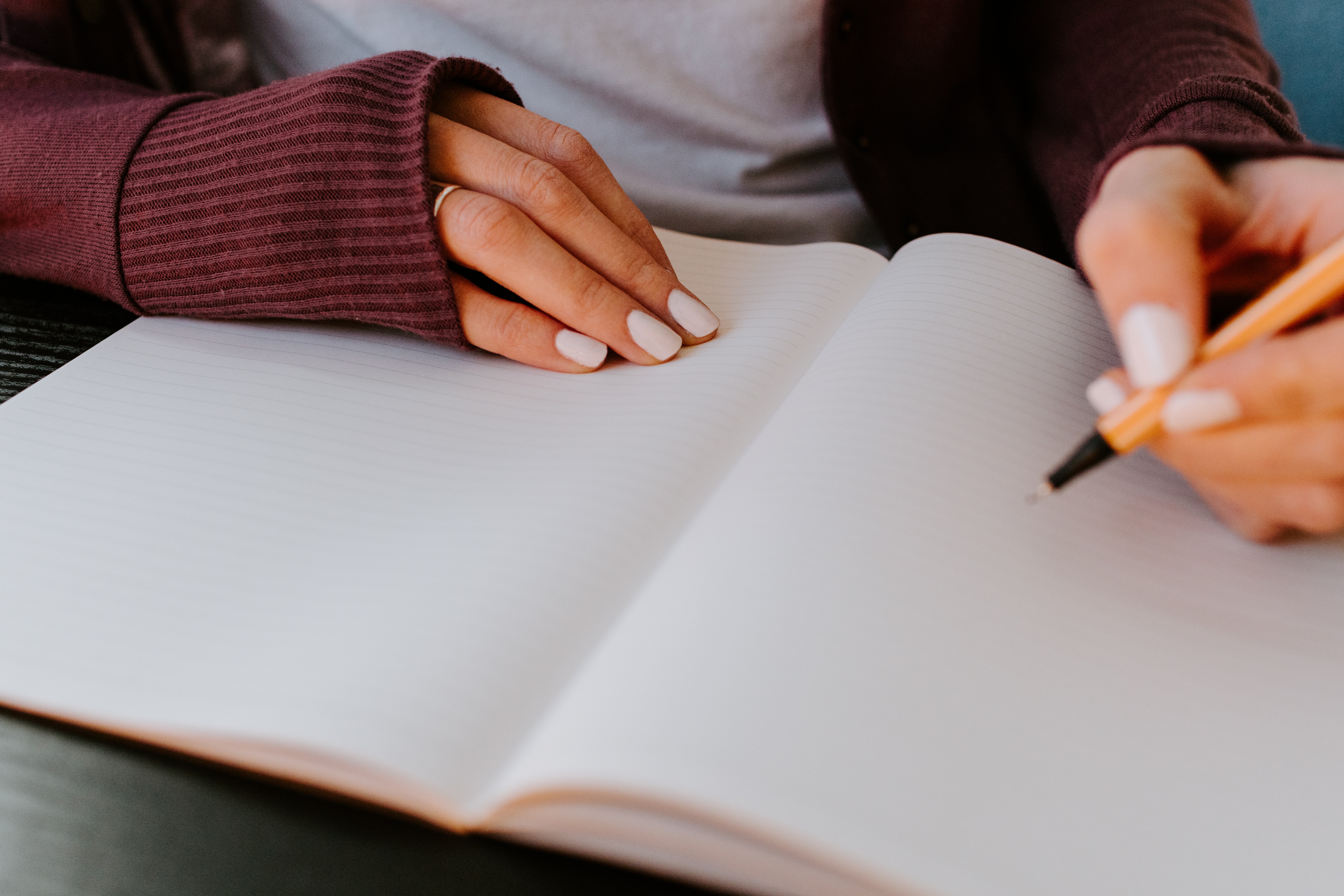 girl with white nails journaling