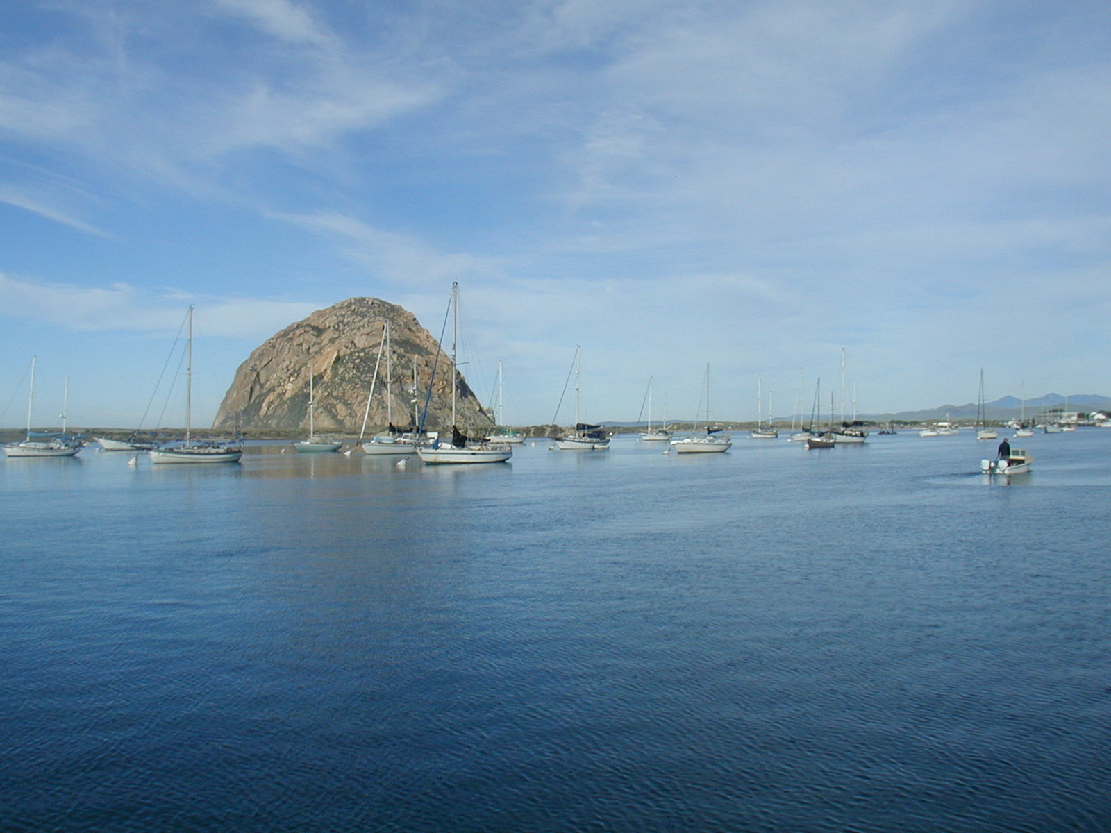 view of morro bay rock from a sailboat in the marina