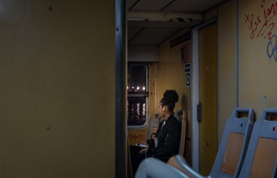 A girl listening to music on the bus