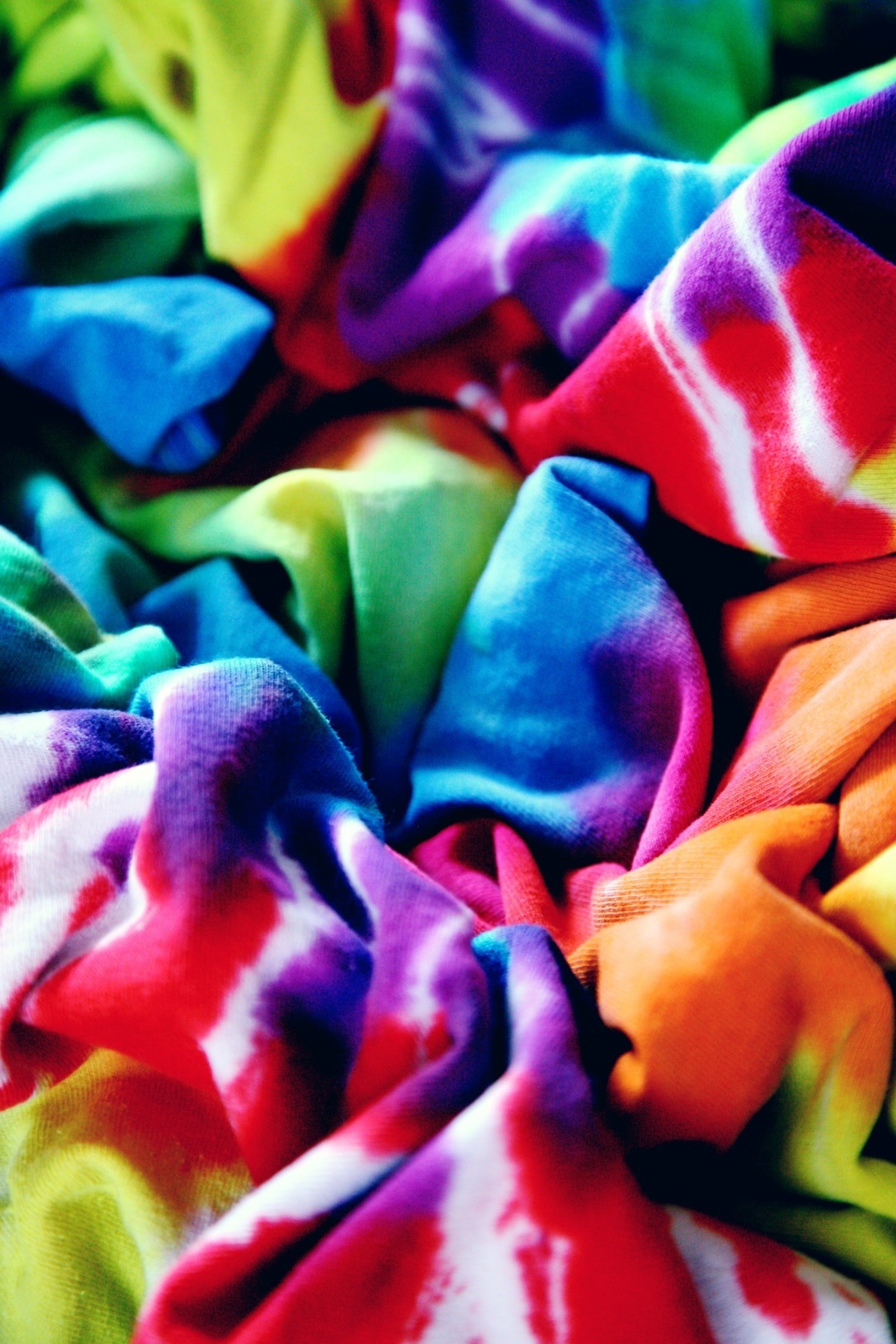 closeup of scrunched tie dye shirts in rainbow colors