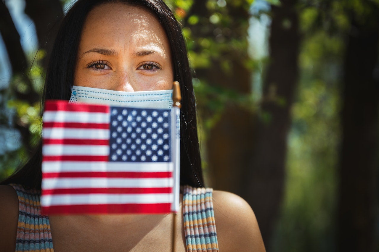 woman with american flag and mask