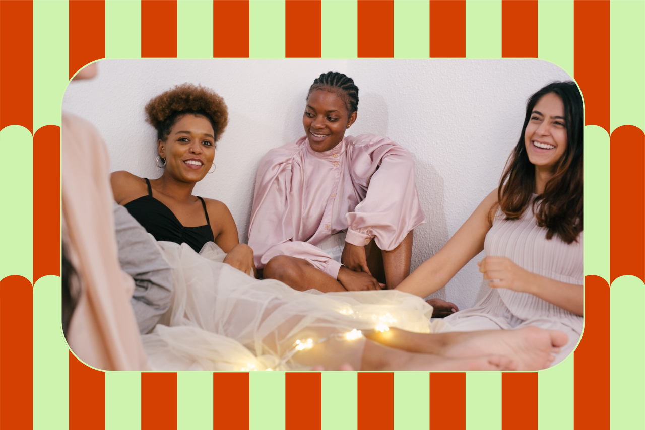 group of women laughing on bed