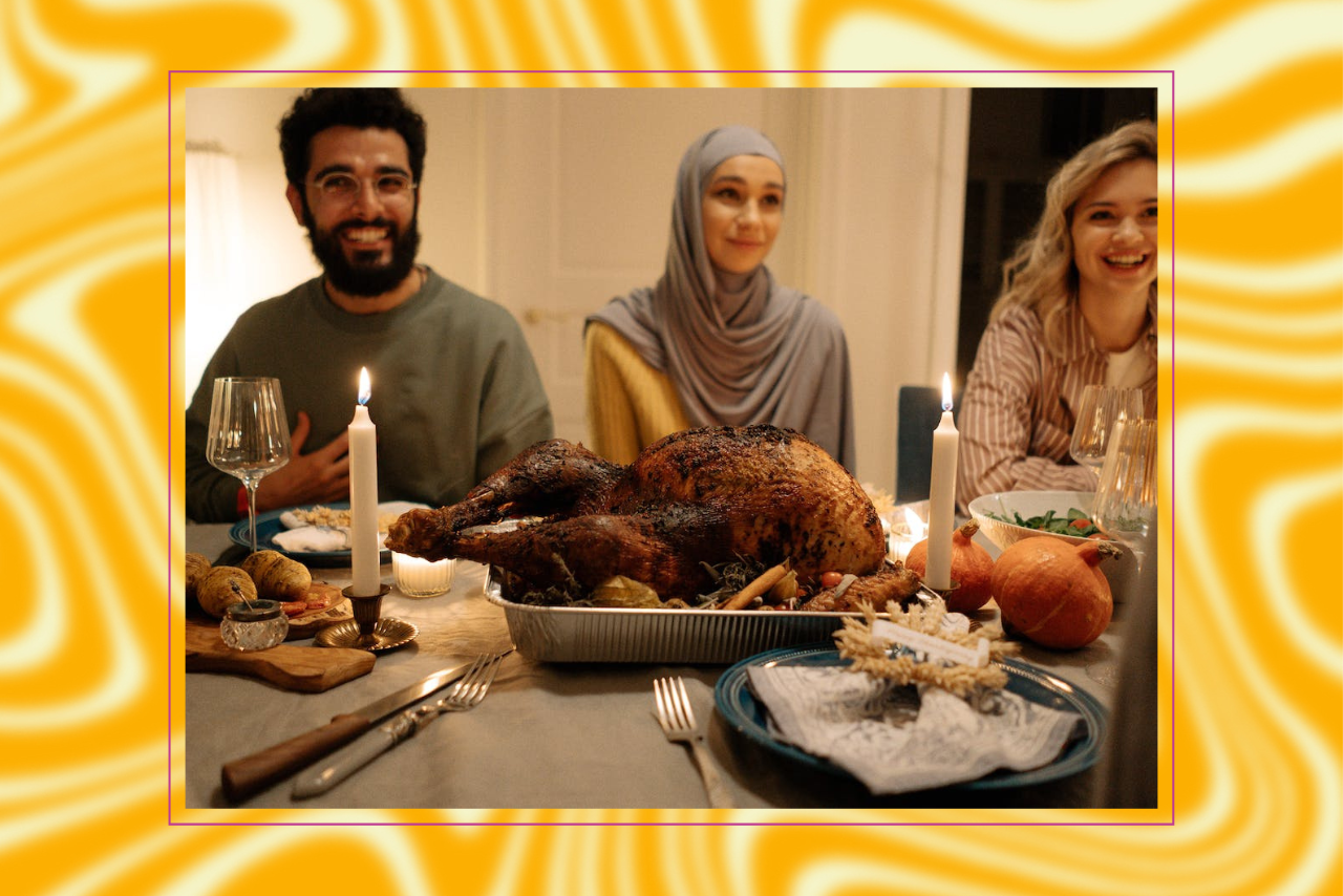 smiling people sitting around thanksgiving table