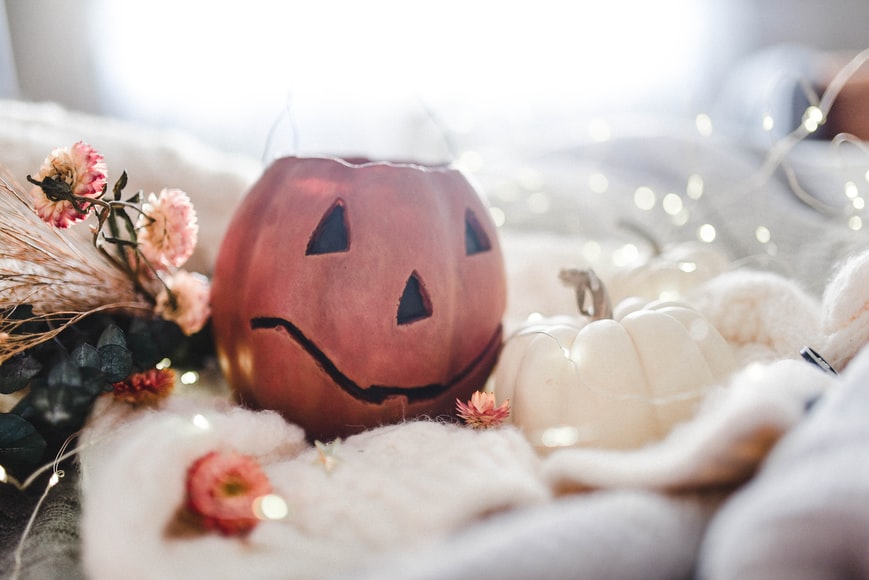 Pumpkins, flowers, and lights on blankets