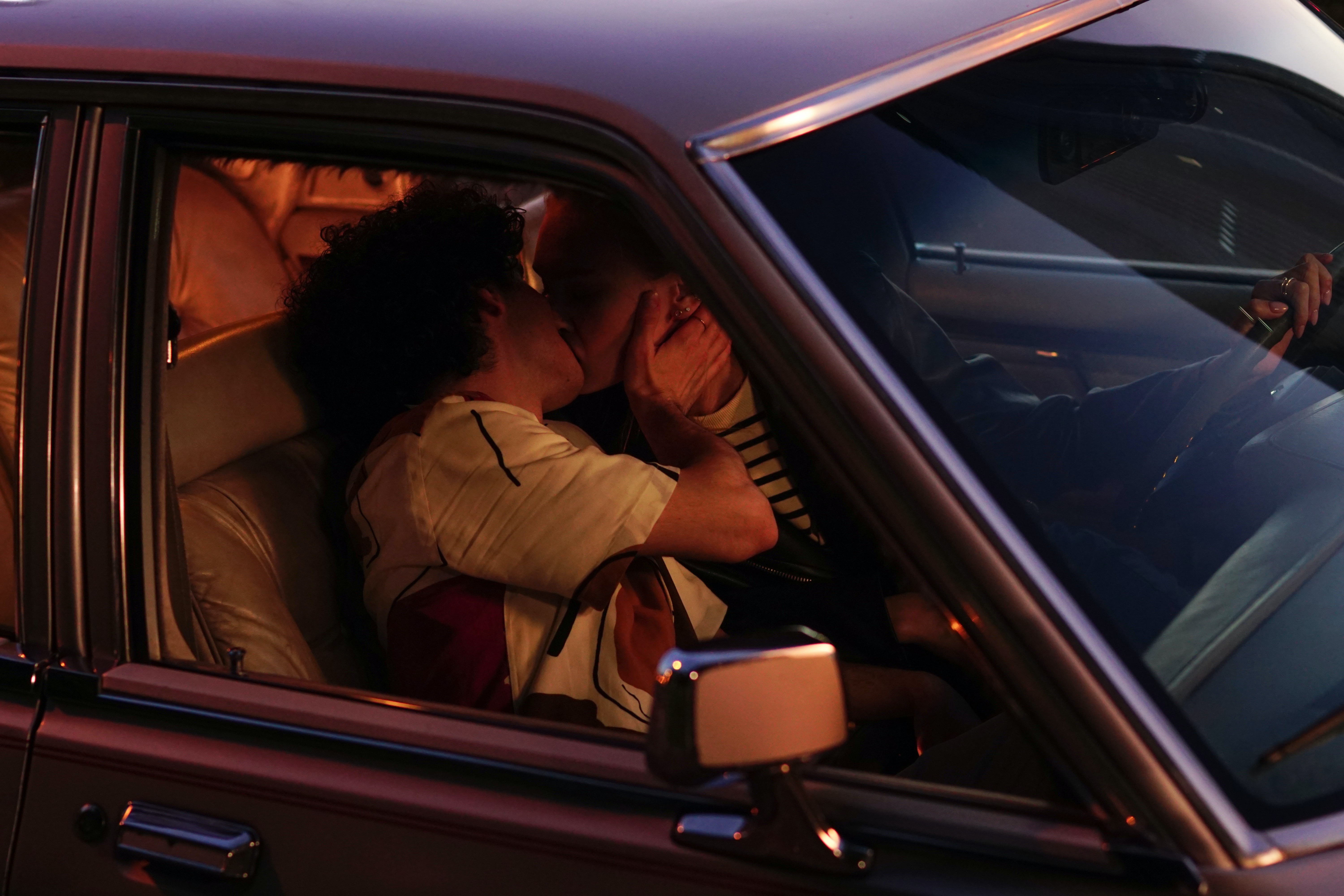 couple kissing in car