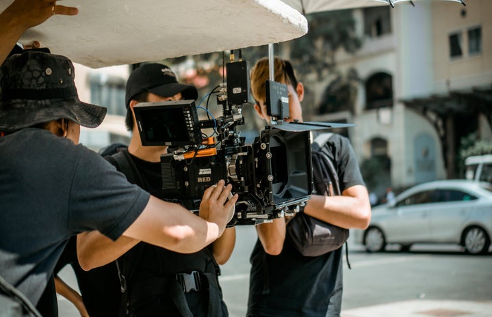 people holding camera for film set