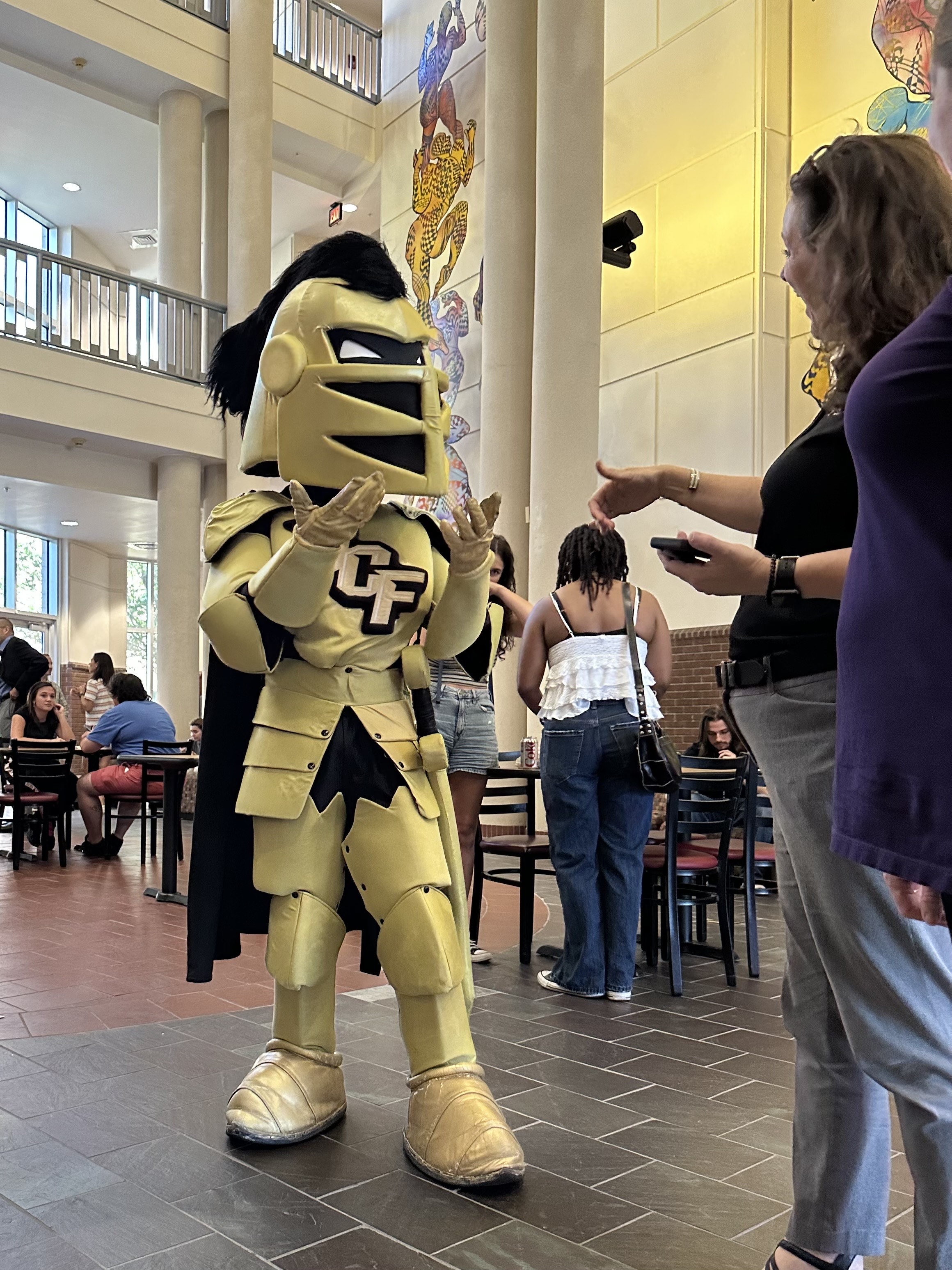 Knightro signing ASL with a UCF professor