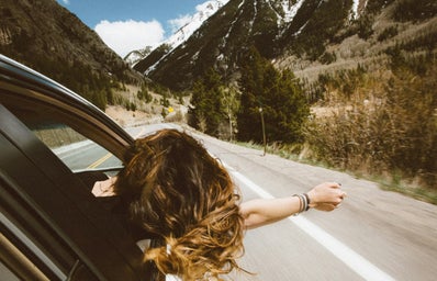 girl leaning out of car window