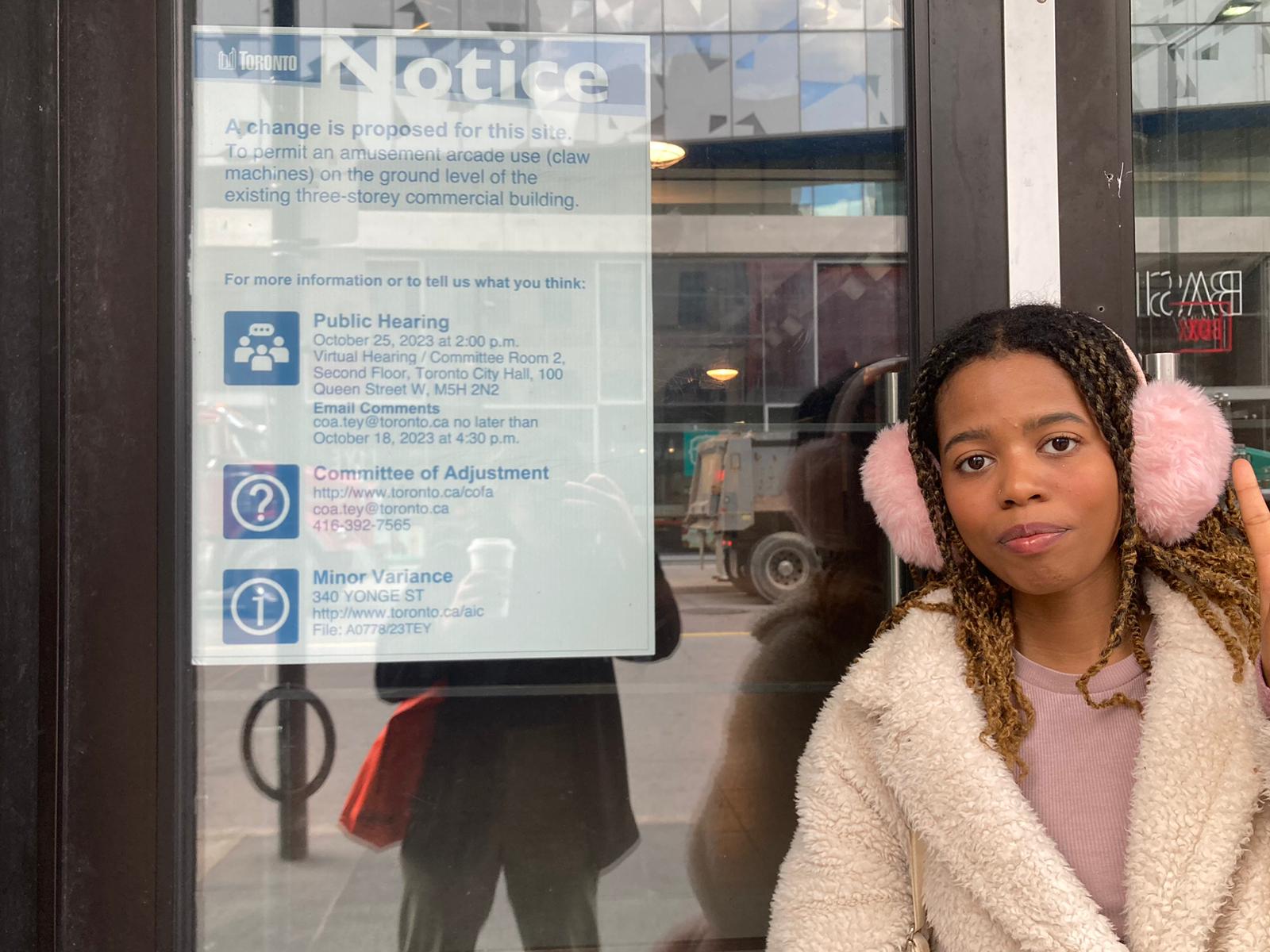 Girl in front of Toronto town notice