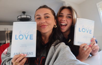 Sara Carrolli and Lauren Syndi posing with book titled \"Twisted Love\"