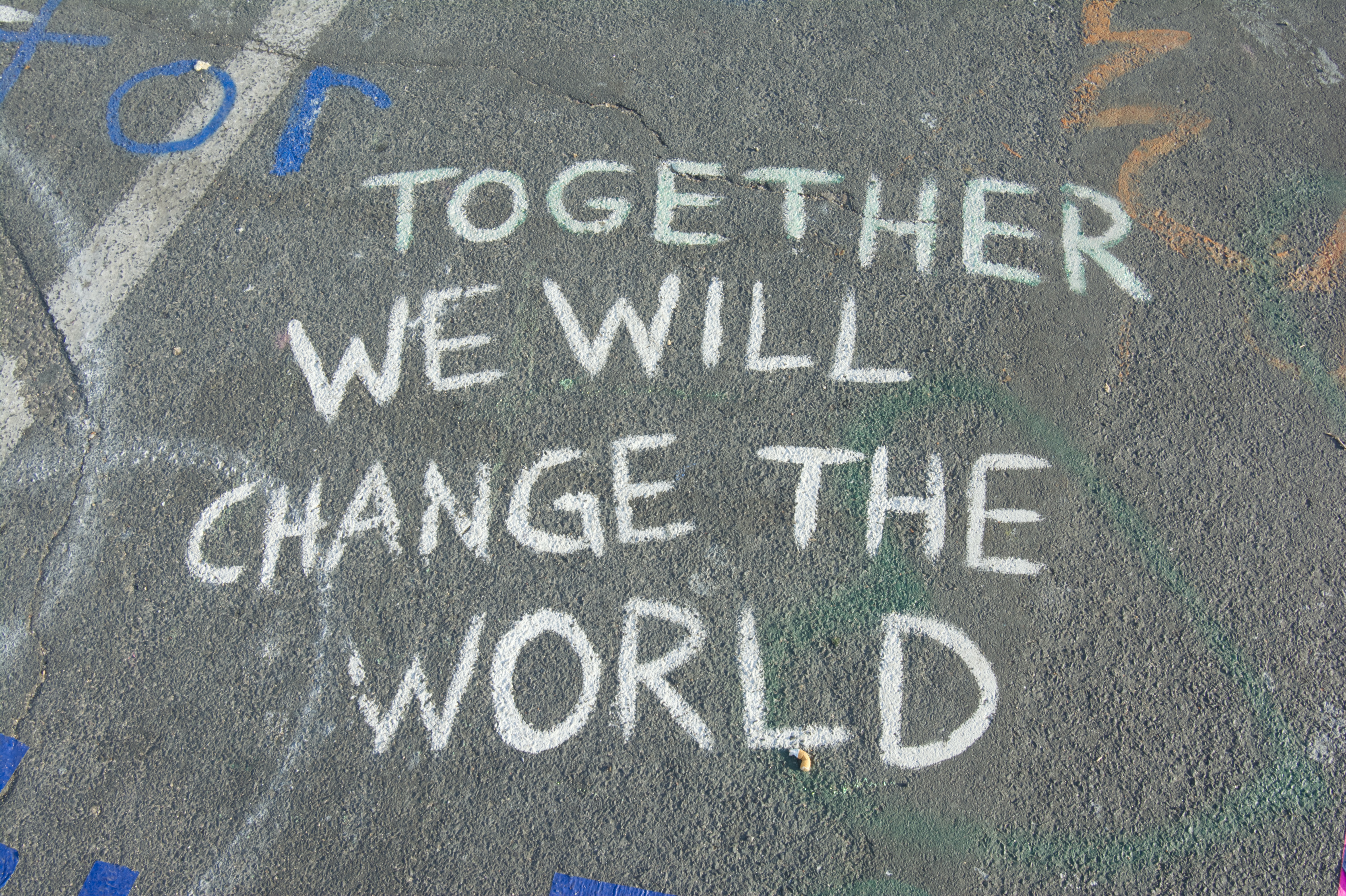 Chalk art that says \"together we will change the world\"