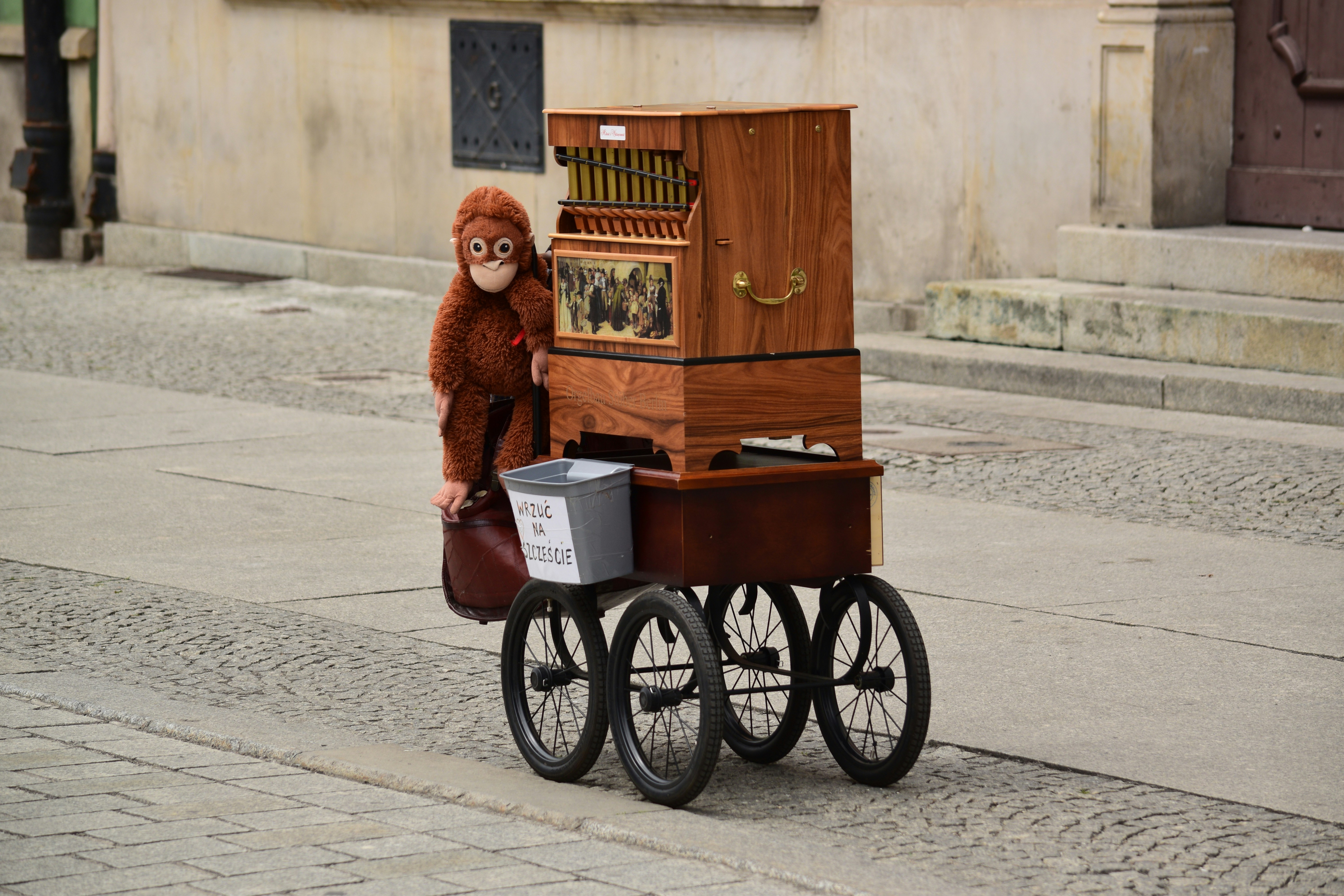 plush monkey atop a wooden cart