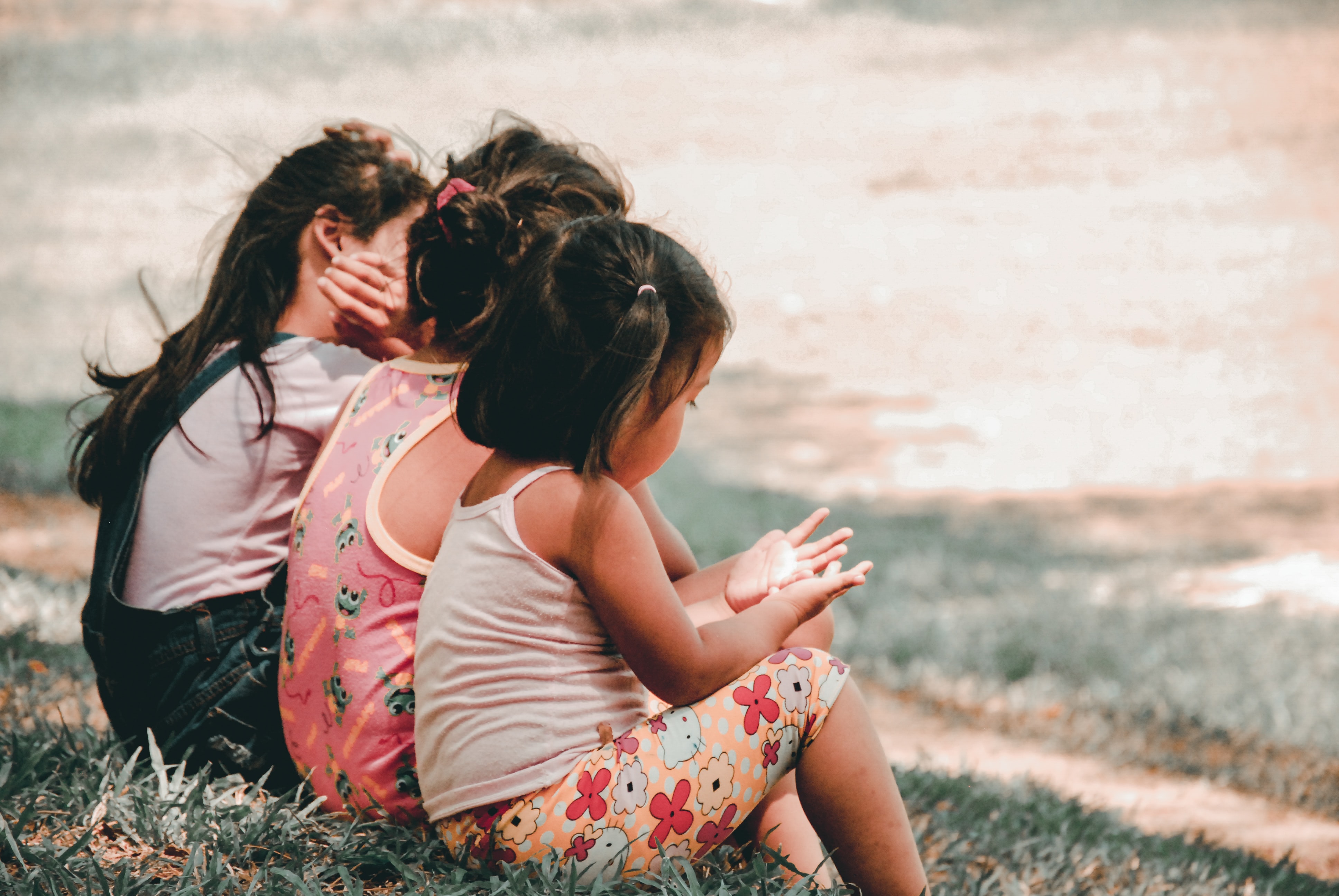 children sitting at the beach