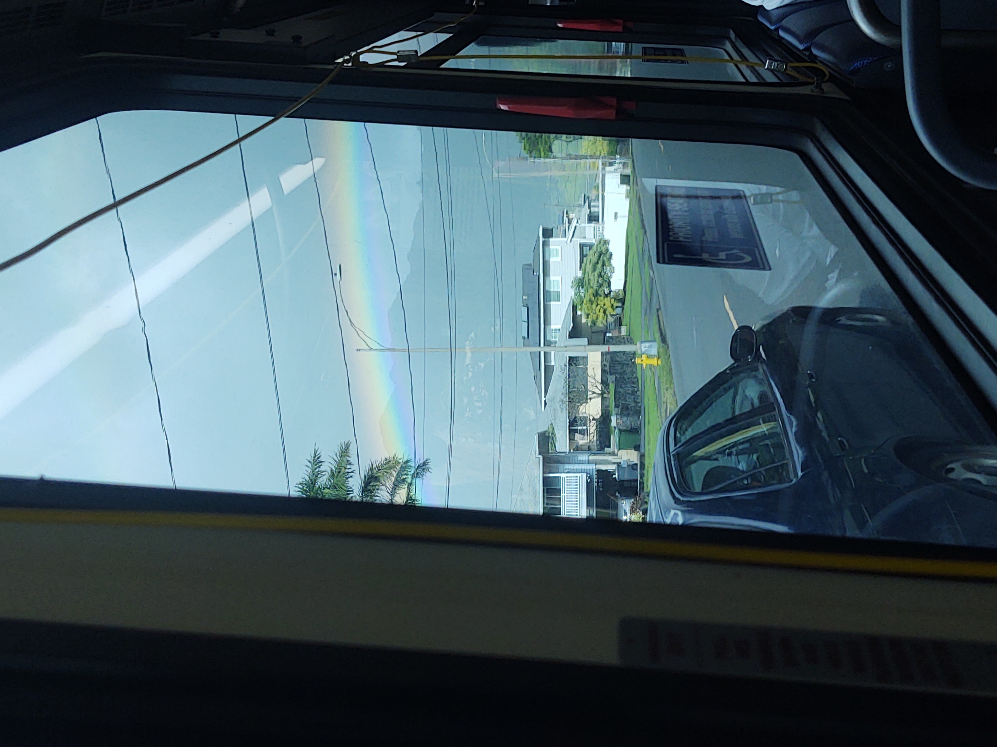 Photo of a rainbow taken on a bus