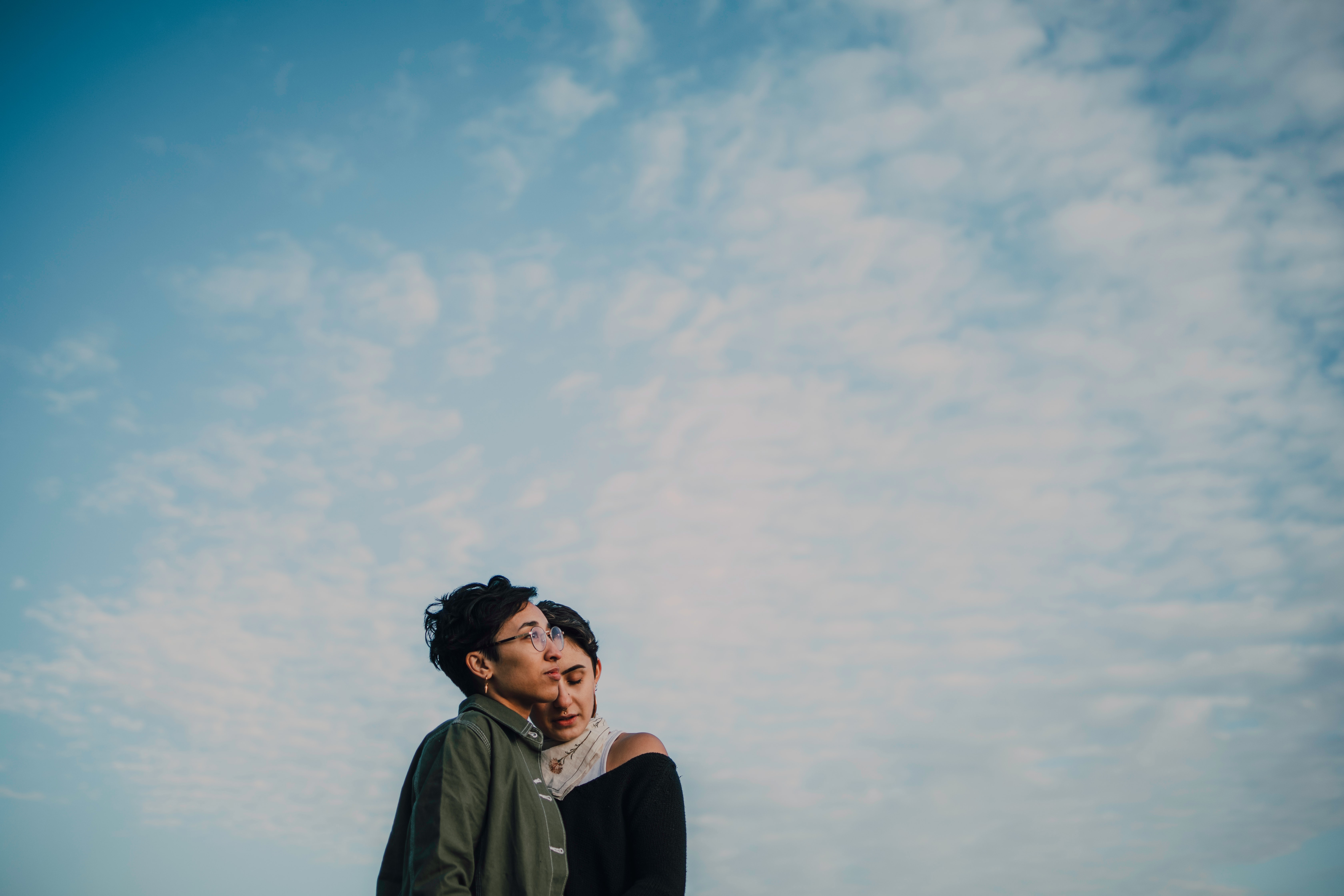 queer couple hugging outside