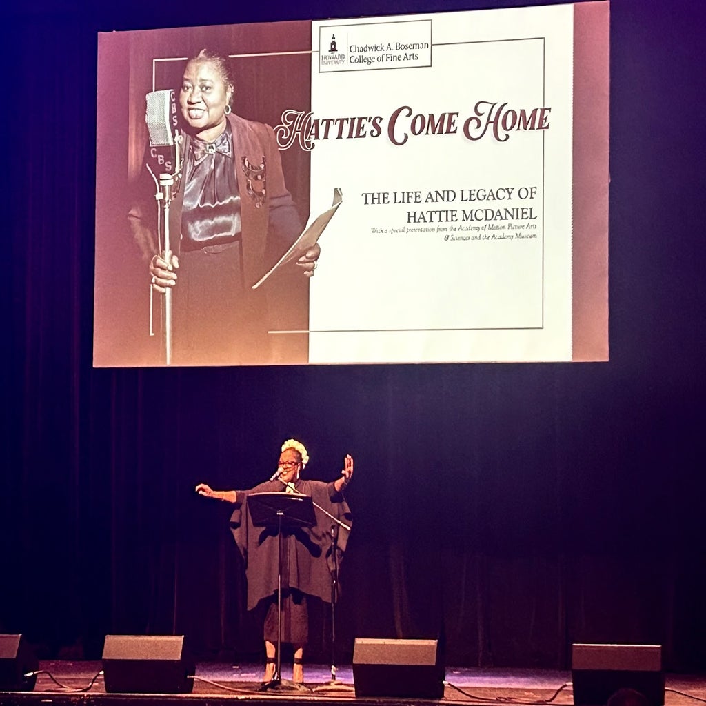 Professor and vocalist Kishna Davis Fowler opens the celebration service with a medley of songs in honor of actress and singer-songwriter Hattie McDaniels on the Cramton Auditorium stage.