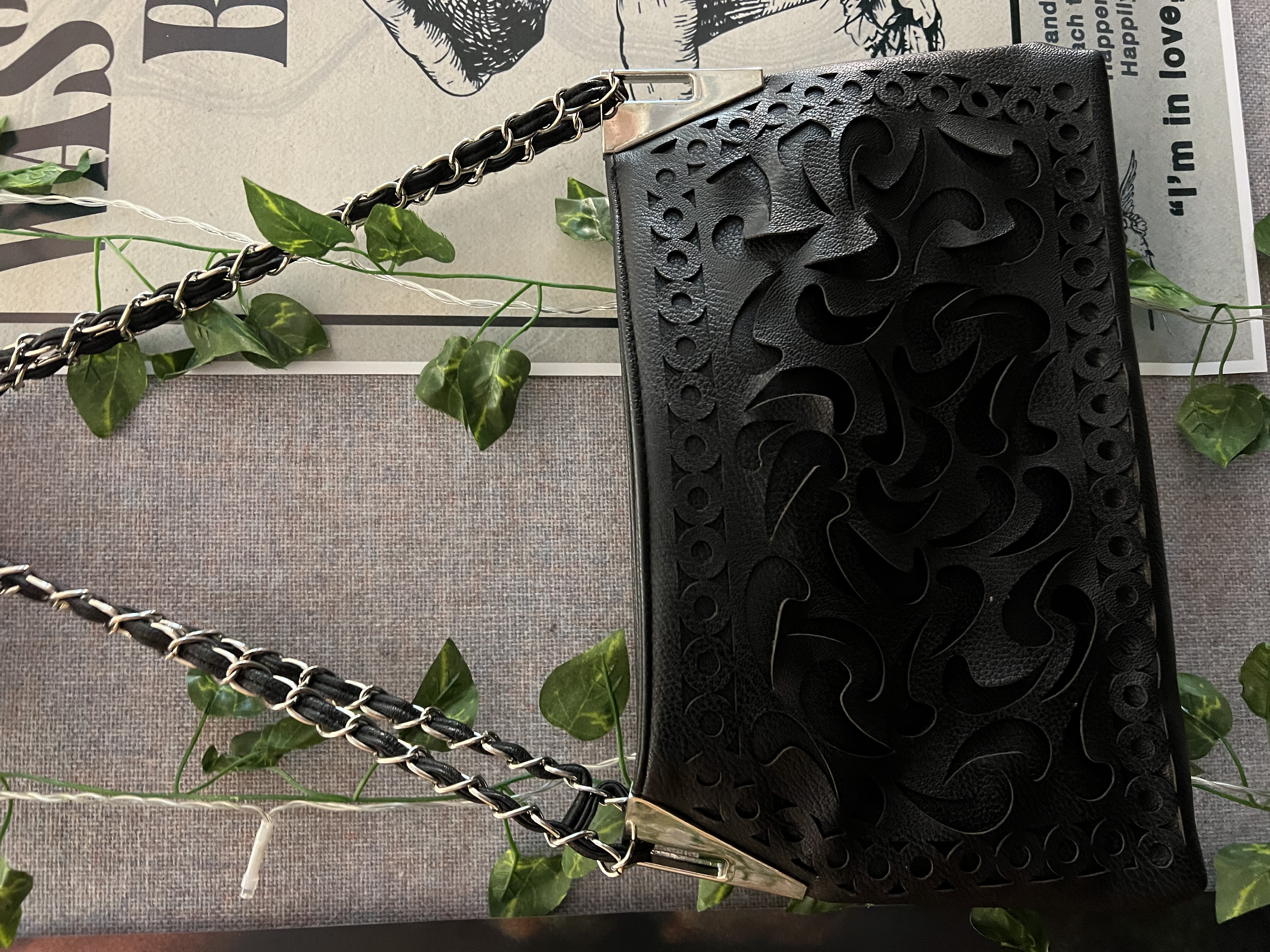 A small black purse hanging on my wall