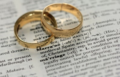 two wedding rings on top of writing