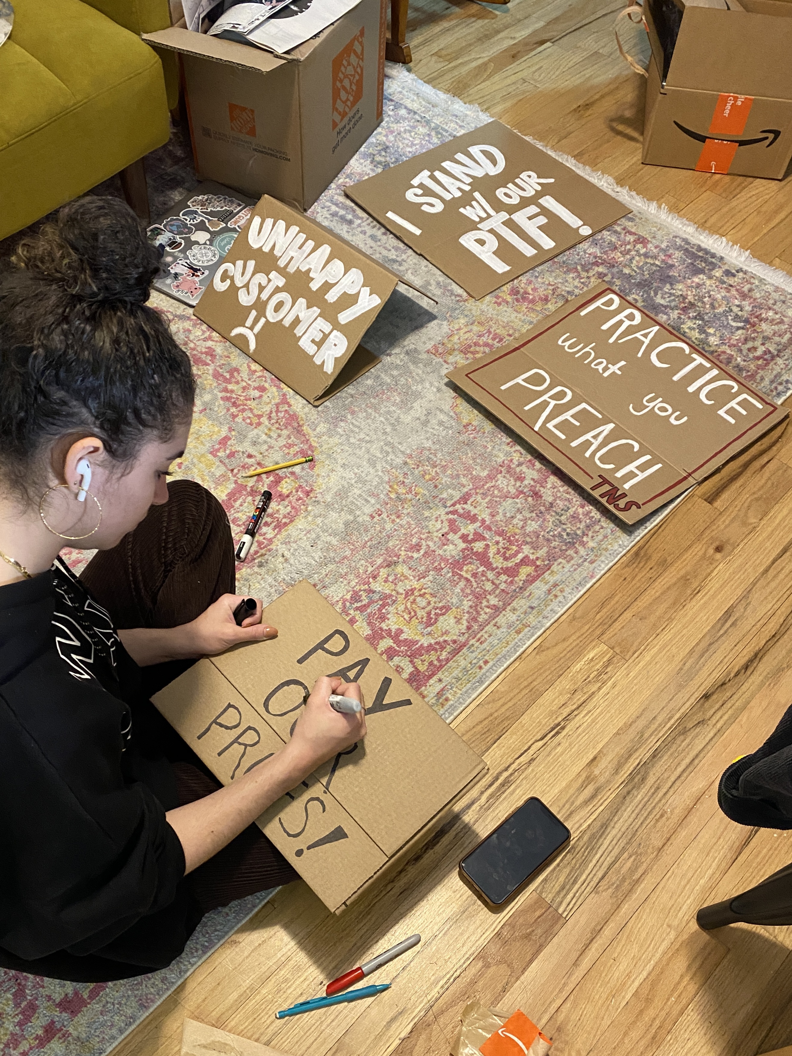 Isabelle Bouvier sitting at home making cardboard signs for a strike.