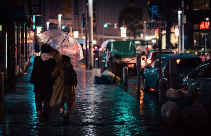 couple walking with an umbrella in the city